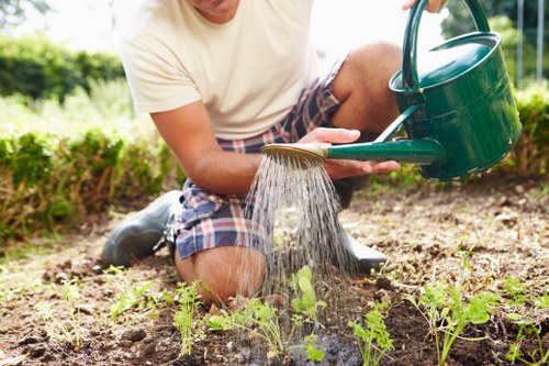 Front view of Wellington-style garden maintenance team preparing tools